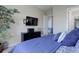 Inviting bedroom with a dresser, large window, and a TV mounted on the wall at 18027 Telford Ave, Parker, CO 80134