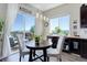 Cozy dining area with large windows and sliding glass doors leading to an outdoor deck with a view at 18027 Telford Ave, Parker, CO 80134