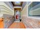 Covered entryway featuring stone accents and a wooden deck leading to the front door at 18027 Telford Ave, Parker, CO 80134