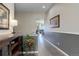 Inviting hallway with modern flooring, neutral paint, and decorative accents at 18027 Telford Ave, Parker, CO 80134