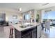 Spacious open-concept kitchen, living room and dining area with stainless steel appliances and lots of natural light at 18027 Telford Ave, Parker, CO 80134