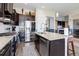 The gourmet kitchen boasts stainless steel appliances, granite countertops, and dark wood cabinets at 18027 Telford Ave, Parker, CO 80134