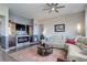 Relaxing living room featuring a fireplace, TV, comfortable seating, and stylish decor at 18027 Telford Ave, Parker, CO 80134
