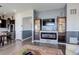 Cozy living room with a fireplace, built-in shelving, and neutral paint at 18027 Telford Ave, Parker, CO 80134