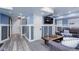 Open-concept basement living area with laminate floors and neutral decor at 18027 Telford Ave, Parker, CO 80134