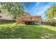 Manicured backyard featuring a wooden deck, mature trees, and a lush lawn at 4580 W 109Th Ave, Westminster, CO 80031