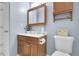 Cozy bathroom featuring a wooden vanity, medicine cabinet, and a complementary wall shelf at 4580 W 109Th Ave, Westminster, CO 80031