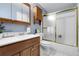 Well-maintained bathroom with a shower-tub combo, wooden vanity, and a mirrored medicine cabinet at 4580 W 109Th Ave, Westminster, CO 80031