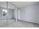 Bedroom showcasing a large mirrored closet and neutral decor offering a bright and airy feel at 4580 W 109Th Ave, Westminster, CO 80031