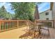 Wooden deck featuring a glass table, seating, and an umbrella with a yard view at 4580 W 109Th Ave, Westminster, CO 80031