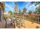 Outdoor wooden deck featuring a glass-topped table, chairs, and umbrella at 4580 W 109Th Ave, Westminster, CO 80031
