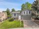 Charming gray two-story home featuring white shutters, a two-car garage, and a well-manicured lawn at 4580 W 109Th Ave, Westminster, CO 80031