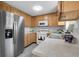 Well-maintained kitchen featuring wood cabinetry, stainless steel refrigerator, and modern appliances at 4580 W 109Th Ave, Westminster, CO 80031