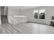 Sunlit living space featuring modern flooring, a large window, and staircase access to upper level at 4580 W 109Th Ave, Westminster, CO 80031
