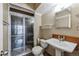 Modern bathroom with a glass-enclosed shower, pedestal sink, and updated fixtures at 1441 N Humboldt St # 504, Denver, CO 80218
