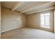 Bright bedroom with exposed beams and a large window, allowing plenty of natural light at 1441 N Humboldt St # 504, Denver, CO 80218