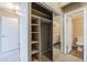 Hallway with closet featuring mirrored sliding doors and access to a bathroom at 1441 N Humboldt St # 504, Denver, CO 80218