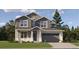 Charming two-story home with grey siding, a stone-accented garage, and a well-manicured lawn at 10760 Snowdon St, Parker, CO 80134