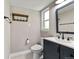Bathroom featuring navy vanity, black hardware, and modern fixtures at 971 Ursula St, Aurora, CO 80011