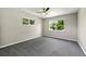 Spacious bedroom with plush gray carpeting and two sunny windows with views at 971 Ursula St, Aurora, CO 80011