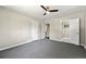 Large bedroom with gray carpet, ceiling fan, and multiple doorways at 971 Ursula St, Aurora, CO 80011