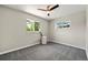 A cozy bedroom featuring neutral walls, grey carpet, and a ceiling fan at 971 Ursula St, Aurora, CO 80011