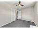This bedroom includes neutral walls, grey carpeting, and white trim at 971 Ursula St, Aurora, CO 80011