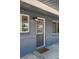 Close-up of front door with stylish lighting and brick exterior at 971 Ursula St, Aurora, CO 80011
