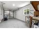 A functional garage space with a workbench, tool storage, and garage door at 971 Ursula St, Aurora, CO 80011
