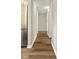 Hallway with new floors and stainless steel refrigerator at 971 Ursula St, Aurora, CO 80011