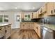 Updated kitchen with stainless steel appliances, granite countertops, and plenty of cabinet space at 971 Ursula St, Aurora, CO 80011