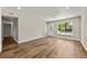 Spacious living room featuring hardwood floors, recessed lighting and a view to the front yard at 971 Ursula St, Aurora, CO 80011