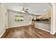Open-concept living room featuring hardwood floors, recessed lighting and neutral paint flowing to kitchen at 971 Ursula St, Aurora, CO 80011