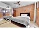 Bright bedroom with brick accent wall and mirrored closet at 5030 Aspen Dr, Littleton, CO 80123