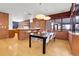 Kitchen dining area with brick wall and modern table at 5030 Aspen Dr, Littleton, CO 80123