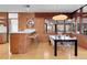 Kitchen dining area with brick wall and modern table at 5030 Aspen Dr, Littleton, CO 80123