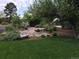 Landscaped front yard with rock water feature at 5030 Aspen Dr, Littleton, CO 80123