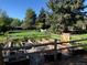 Landscaped garden with raised garden beds and wooden fence at 5030 Aspen Dr, Littleton, CO 80123