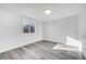 Bright bedroom with grey wood-look floors and a window at 6643 W 96Th Ave, Broomfield, CO 80021