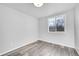 Well-lit bedroom with grey wood-look floors and a window at 6643 W 96Th Ave, Broomfield, CO 80021