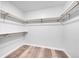 Walk-in closet with wood shelving and hanging rods at 6643 W 96Th Ave, Broomfield, CO 80021