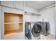 Laundry room with washer, dryer, shelving, and cabinets at 6643 W 96Th Ave, Broomfield, CO 80021