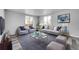 Modern living room with gray sofas and a glass coffee table at 6643 W 96Th Ave, Broomfield, CO 80021