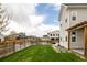 A fenced-in backyard featuring a lush green lawn with a patio area and pergola at 10106 E 59Th Pl, Denver, CO 80238