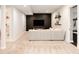 Finished basement with a modern TV wall and comfortable seating area, adjacent to a sleek bathroom at 10106 E 59Th Pl, Denver, CO 80238