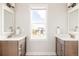 Bathroom featuring dual vanities and a large window providing natural light and neighborhood views at 10106 E 59Th Pl, Denver, CO 80238