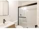 Modern bathroom with black framed shower, a sleek vanity, and contemporary fixtures, creating a minimalist design at 10106 E 59Th Pl, Denver, CO 80238
