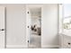 Bright bedroom showcases a glimpse into a tranquil bedroom and bathroom with herringbone flooring at 10106 E 59Th Pl, Denver, CO 80238