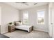 Cozy bedroom with a twin bed, a rustic nightstand, and bright windows offering neighborhood views at 10106 E 59Th Pl, Denver, CO 80238
