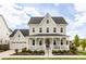 Charming two-story home featuring a welcoming front porch and attached two-car garage at 10106 E 59Th Pl, Denver, CO 80238